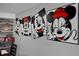 Dining area with Mickey Mouse wall art and dark wood table at 2452 Sweetwater Club Cir # 27, Kissimmee, FL 34746