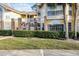 Condo building exterior, showcasing entrance and landscaping at 2452 Sweetwater Club Cir # 27, Kissimmee, FL 34746