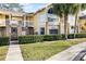Condo building exterior, showing entrance and landscaping at 2452 Sweetwater Club Cir # 27, Kissimmee, FL 34746