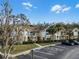 Condo building exterior, showing multiple units and parking at 2452 Sweetwater Club Cir # 27, Kissimmee, FL 34746