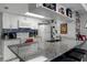 White kitchen with granite countertops, breakfast bar, and Mickey Mouse decor at 2452 Sweetwater Club Cir # 27, Kissimmee, FL 34746