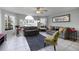 Living room with gray sofas and green accent chair at 2452 Sweetwater Club Cir # 27, Kissimmee, FL 34746