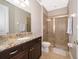 Clean bathroom with shower, granite countertop, and dark wood cabinets at 250 Pendant Ct, Kissimmee, FL 34747