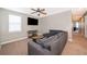Bonus room with sectional sofa, TV, and view of hallway at 250 Pendant Ct, Kissimmee, FL 34747