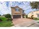 Two-story house with brown brick driveway and landscaping at 250 Pendant Ct, Kissimmee, FL 34747