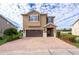 Two-story house with brown brick driveway and landscaping at 250 Pendant Ct, Kissimmee, FL 34747
