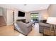 Bright living room with patio access, tile floors, and comfortable seating at 250 Pendant Ct, Kissimmee, FL 34747