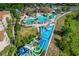 Resort-style pool and water park with slides; lush landscaping at 2774 Almaton Loop # 305, Kissimmee, FL 34747