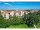 Three-story apartment building with brown roofs and lush green surroundings at 2774 Almaton Loop # 305, Kissimmee, FL 34747