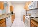 Well-equipped kitchen featuring granite counters and wood cabinets at 2774 Almaton Loop # 305, Kissimmee, FL 34747