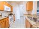 View of kitchen with granite countertops and wood cabinets at 2774 Almaton Loop # 305, Kissimmee, FL 34747