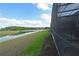 Lush backyard view from the screened-in patio, overlooking the serene pond at 2797 Bookmark Dr, Kissimmee, FL 34746