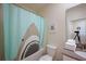 A quirky bathroom with a shark-themed shower curtain, clean white towels, and modern fixtures at 2797 Bookmark Dr, Kissimmee, FL 34746