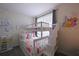 bedroom featuring a white bunk bed, princess decals, and a window with blinds at 2797 Bookmark Dr, Kissimmee, FL 34746