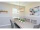 Dining area features a large table with seating for eight and modern art at 2797 Bookmark Dr, Kissimmee, FL 34746