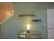 Bright entryway featuring a glass-topped console table, decorative shelving, and stairway access at 2797 Bookmark Dr, Kissimmee, FL 34746