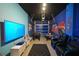 A media room ready for gaming, complete with comfortable seating, and a mounted television at 2797 Bookmark Dr, Kissimmee, FL 34746