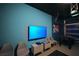 Home entertainment space with large TV for immersive gaming or movie experience, and a foosball table at 2797 Bookmark Dr, Kissimmee, FL 34746