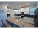 Bright kitchen features white cabinets, stainless steel appliances, and a large center island at 2797 Bookmark Dr, Kissimmee, FL 34746
