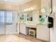 Elegant bathroom with a vanity, large mirror, and walk-in shower at 301 Anastasia Dr, Kissimmee, FL 34759