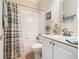 Clean bathroom with a striped shower curtain, white vanity, and tiled floors at 301 Anastasia Dr, Kissimmee, FL 34759