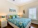 Bedroom with a floral comforter, a white nightstand, and a window with plantation shutters at 301 Anastasia Dr, Kissimmee, FL 34759