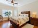 Bedroom with tropical bedding, ceiling fan, and large window with plantation shutters at 301 Anastasia Dr, Kissimmee, FL 34759