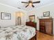Bedroom with tropical bedding, dresser, and access to the bathroom at 301 Anastasia Dr, Kissimmee, FL 34759