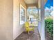 Front porch with yellow chair and brick flooring at 301 Anastasia Dr, Kissimmee, FL 34759
