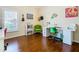 Home office with built-in desk, green chair, and plenty of shelving at 301 Anastasia Dr, Kissimmee, FL 34759