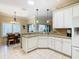 Open kitchen boasts granite counters, white cabinets, and breakfast bar at 301 Anastasia Dr, Kissimmee, FL 34759