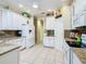 White kitchen with granite countertops and stainless steel appliances at 301 Anastasia Dr, Kissimmee, FL 34759