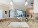 Kitchen features a large island with a sink and granite countertops at 301 Anastasia Dr, Kissimmee, FL 34759