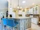 Spacious kitchen with white cabinets, granite counters, and an island with seating at 301 Anastasia Dr, Kissimmee, FL 34759