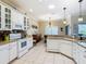 Open kitchen with white cabinets, granite counters, and island at 301 Anastasia Dr, Kissimmee, FL 34759