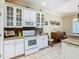 Bright kitchen with white cabinets, granite counters, and a breakfast nook at 301 Anastasia Dr, Kissimmee, FL 34759