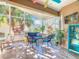 Bright screened porch features wicker furniture and tiled floor at 301 Anastasia Dr, Kissimmee, FL 34759