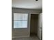 Simple bedroom with window, closet, and tile floor at 3036 Parkway Blvd # 106, Kissimmee, FL 34747