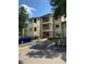 Condo building exterior with parking and landscaping at 3036 Parkway Blvd # 106, Kissimmee, FL 34747