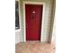Red front door entrance to condo unit at 3036 Parkway Blvd # 106, Kissimmee, FL 34747