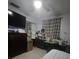 Functional bedroom with a ceiling fan, mirrored closet and sewing machines at 372 La Paz Dr, Kissimmee, FL 34743