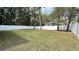 Fenced back yard featuring green grass and plenty of shade trees at 3839 Se 132Nd Pl, Belleview, FL 34420