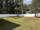 Expansive backyard featuring lush grass and a modern white fence, providing a secure outdoor area at 3839 Se 132Nd Pl, Belleview, FL 34420