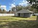 Lush backyard surrounded by a pristine white fence, providing a secure and private outdoor space at 3839 Se 132Nd Pl, Belleview, FL 34420