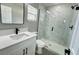 Bathroom featuring a new glass-enclosed shower, white vanity, and modern fixtures at 3839 Se 132Nd Pl, Belleview, FL 34420