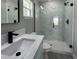 Bright bathroom with a new marble-look glass-enclosed shower, white vanity, and modern black fixtures at 3839 Se 132Nd Pl, Belleview, FL 34420