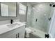Bathroom featuring a new glass-enclosed shower, white vanity, and modern fixtures at 3839 Se 132Nd Pl, Belleview, FL 34420