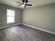 Bedroom with large window, gray walls, and light-colored trim provides ample natural light at 3839 Se 132Nd Pl, Belleview, FL 34420