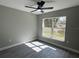 Sunlight streaming through the large window illuminates this bedroom. Gray walls, light trim at 3839 Se 132Nd Pl, Belleview, FL 34420