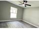 Vaulted ceiling in this bedroom, with a window and modern ceiling fan at 3839 Se 132Nd Pl, Belleview, FL 34420